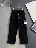 Black cargo pants with elastic waistband and drawstring, side pockets