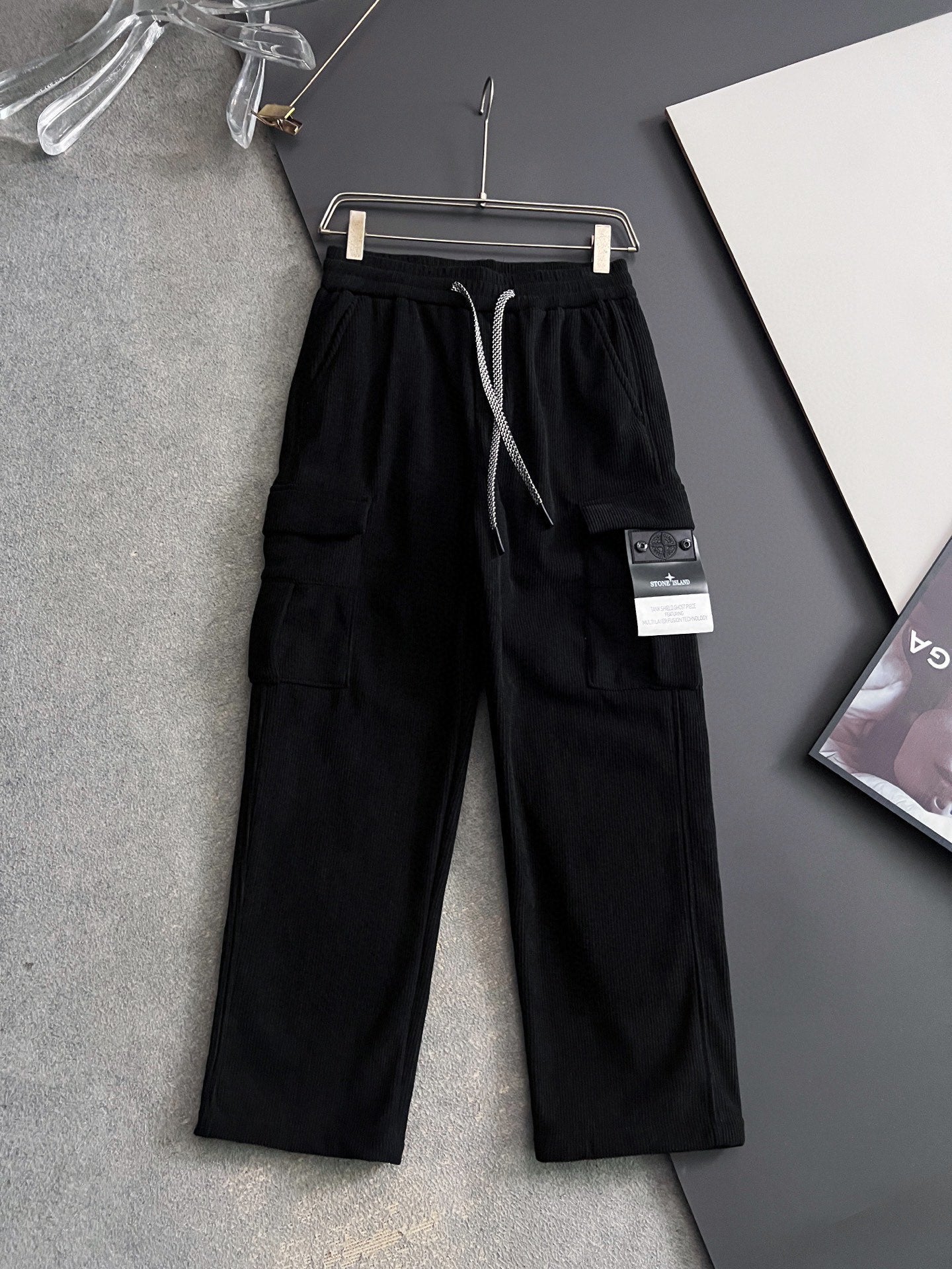 Black cargo pants with elastic waistband and drawstring, side pockets