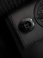 Embossed Stone Island logo on dark fabric patch