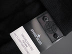 Stone Island fabric label patch on dark inner lining