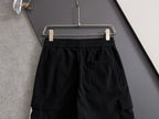 Black cargo pants rear view with elastic waistband and cargo pocket detail