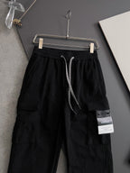 Black cargo pants with drawstring and side cargo pocket, sewn fabric label