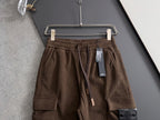 Brown cargo pants on hanger with elastic waistband, drawstring, and pocket detail