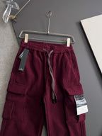 Burgundy cargo pants on hanger with elastic waistband and drawstring