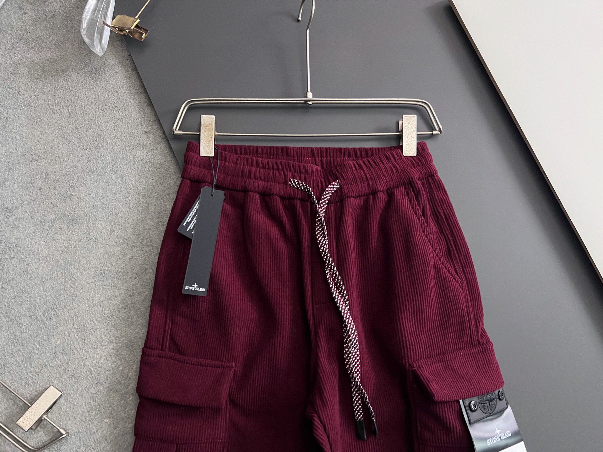 Burgundy cargo pants with drawstring and cargo pockets, elastic waistband