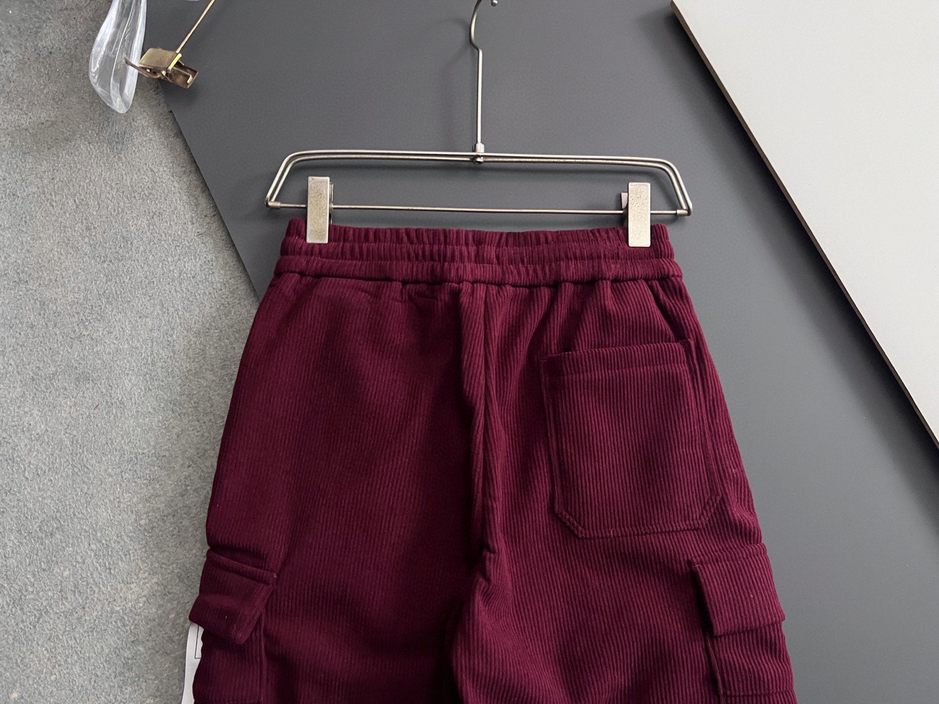 Burgundy cargo pants with elastic waistband, drawstring, and side cargo pocket