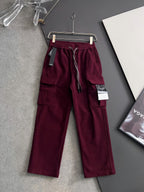 Burgundy cargo pants with drawstring, elastic waistband, and side pockets