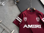 Burgundy crewneck T-shirt with AMIRI lettering and crest logos on the chest