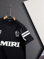 Black T-shirt with AMIRI crest emblem and striped sleeve stripe detail
