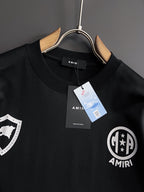 Black crewneck T-shirt with AMIRI crest emblem and hanging product tags