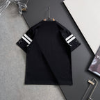 Black T-shirt with striped sleeve cuffs, shown from the back on a hanger