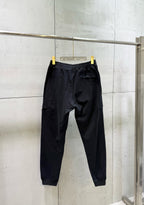 Black cargo pants with tapered legs and ankle cuffs