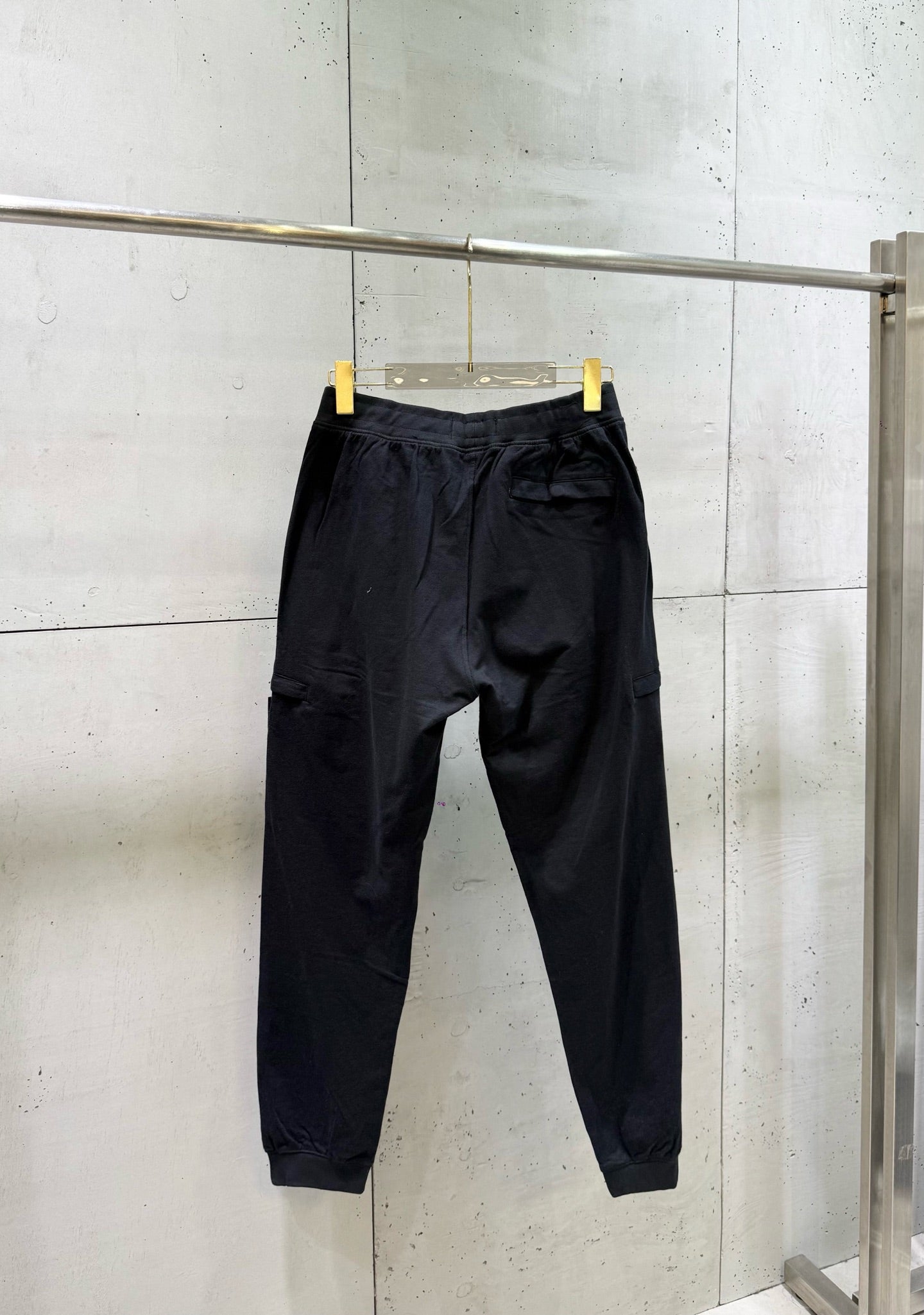 Black cargo pants with tapered legs and ankle cuffs