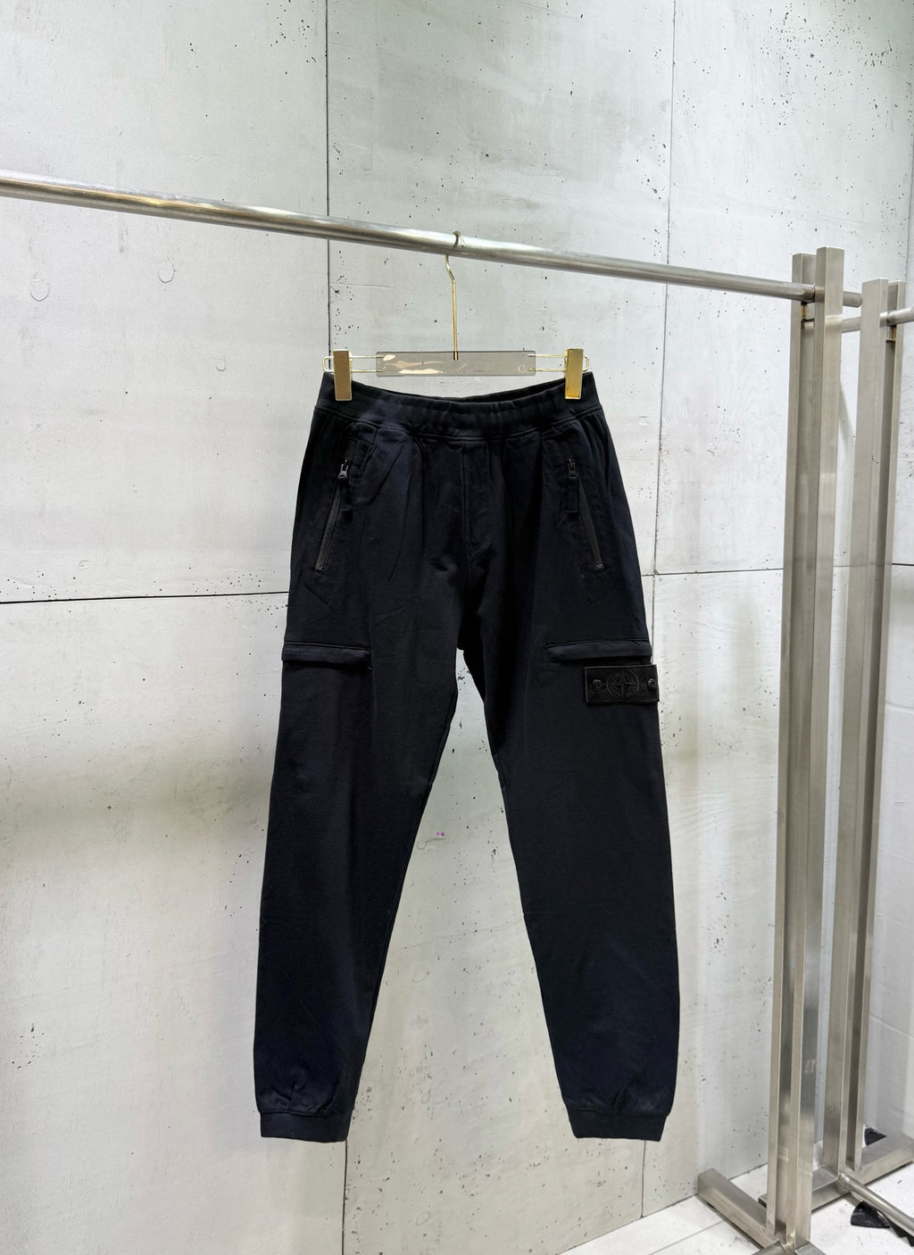 Black cargo pants with elastic waistband and flap side pockets