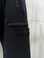 Black cargo pants with logo patch detail near side pocket