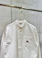 White long-sleeve button-up shirt with chest pocket and embroidered logo
