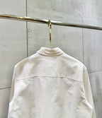 White long-sleeve button-up shirt back view with curved yoke