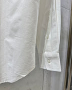 White shirt cuff with button placket and folded sleeve