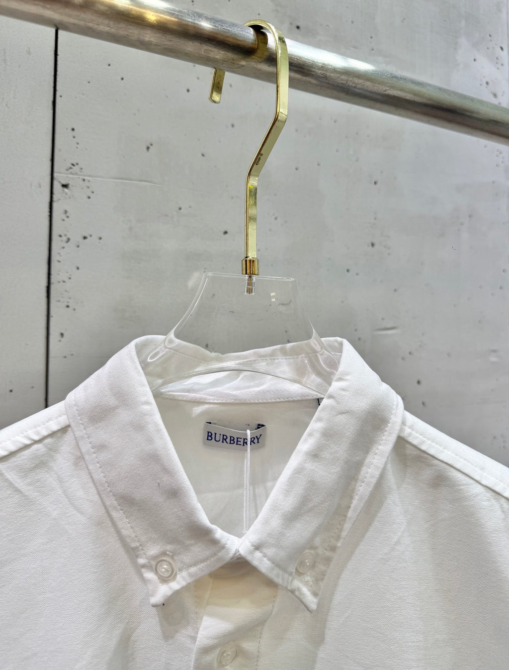 White button-up shirt neckline with Burberry label and collar