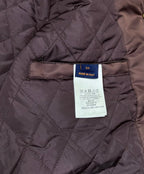 Quilted burgundy bomber jacket interior with size and care label tag