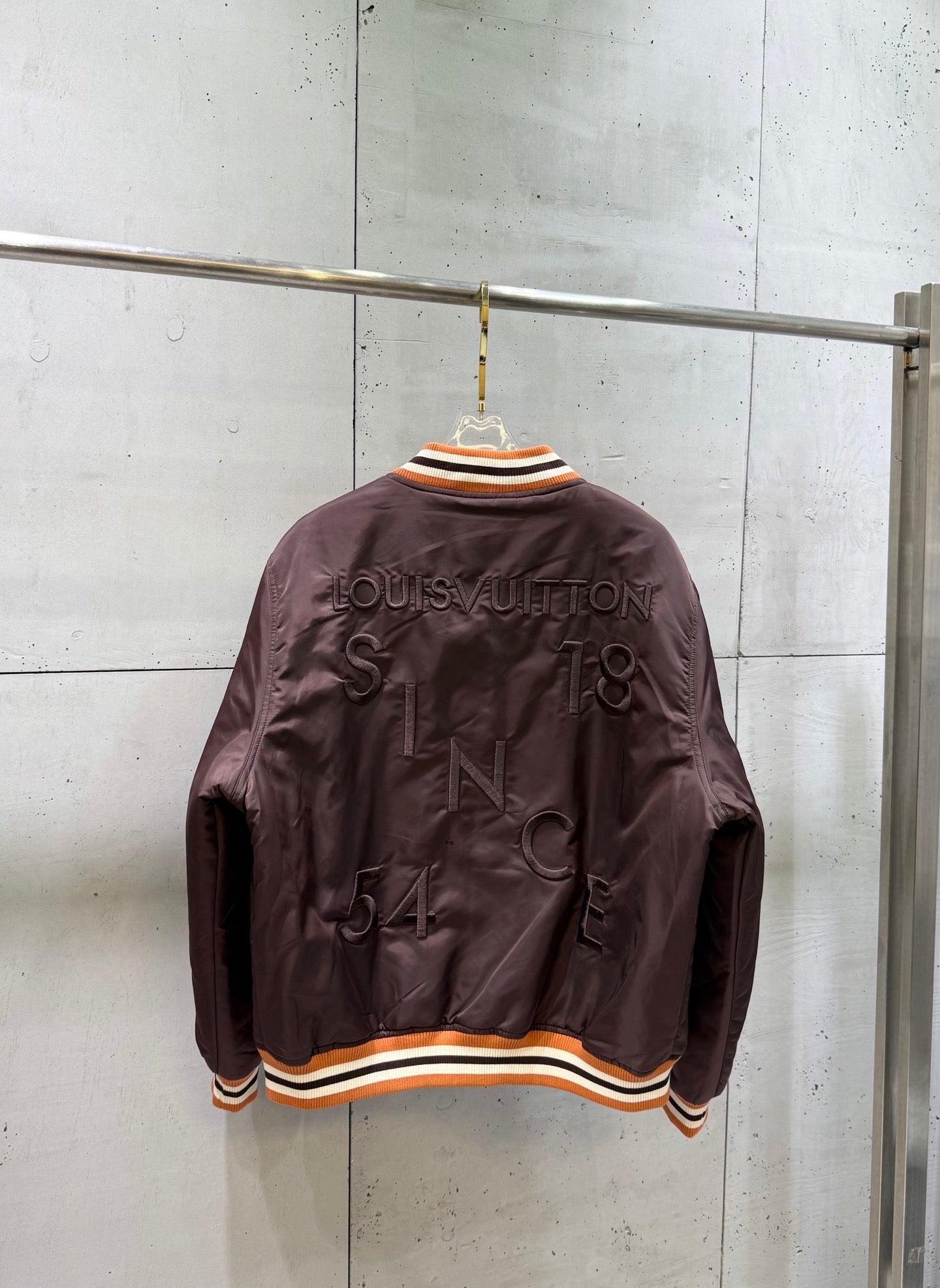 Burgundy bomber jacket with striped ribbed hem and back Louis Vuitton graphic