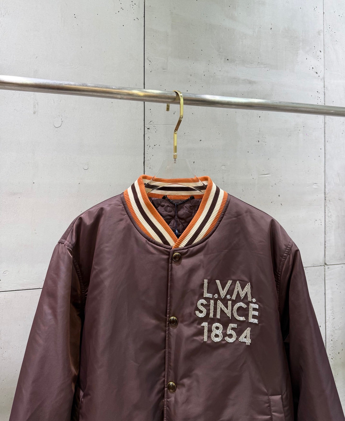 Burgundy bomber jacket with striped V-neck ribbing, snap front, LV Since 1854