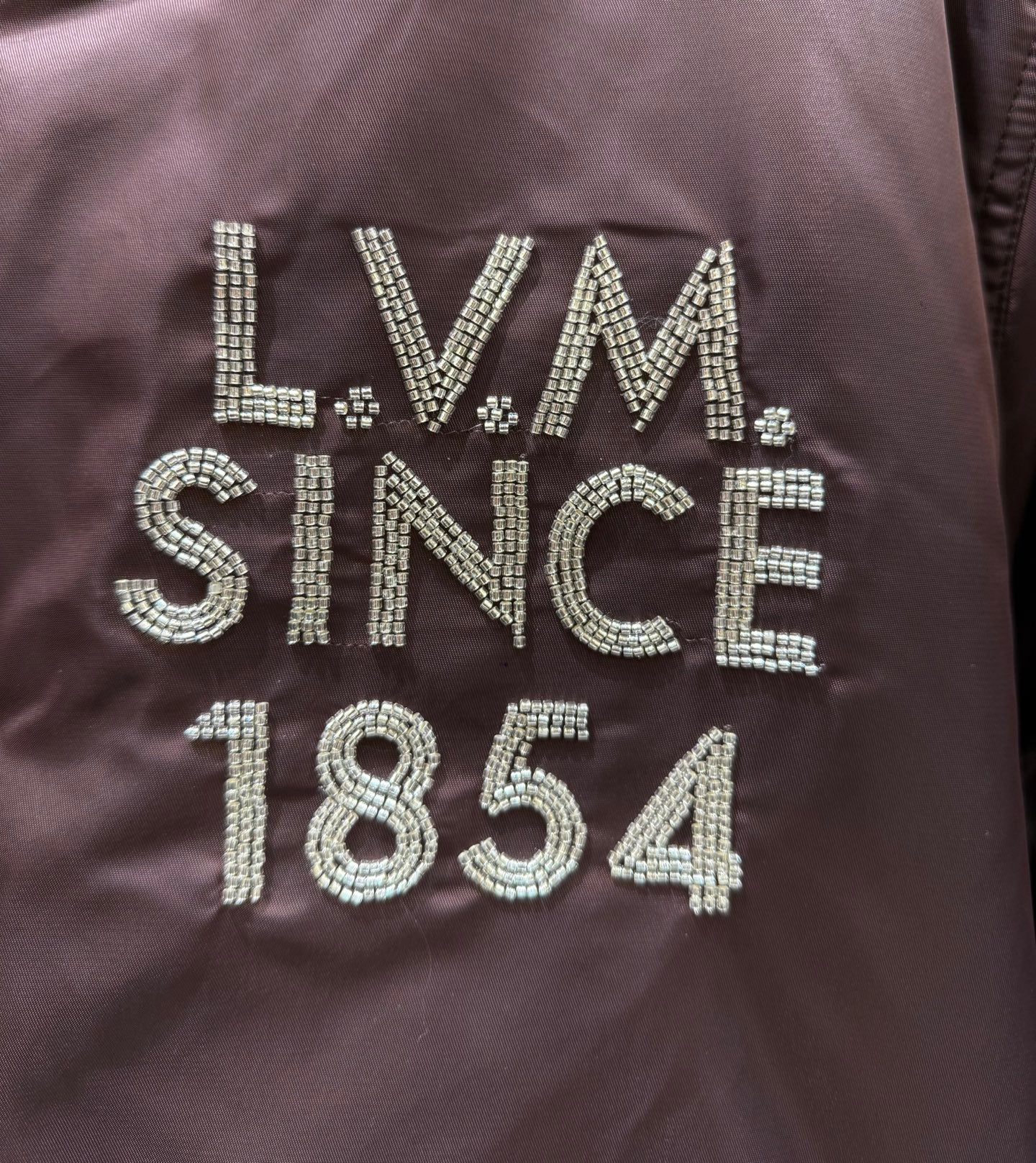 Burgundy bomber jacket logo text LV Since 1854 with rhinestone embellishment