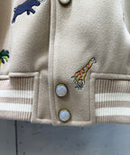 Louis Vuitton jacket front close-up with snap buttons and colorful animal embroidery.
