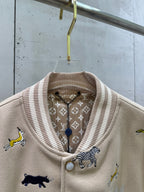 Louis Vuitton varsity jacket close-up: ribbed stand collar with patterned lining and button.