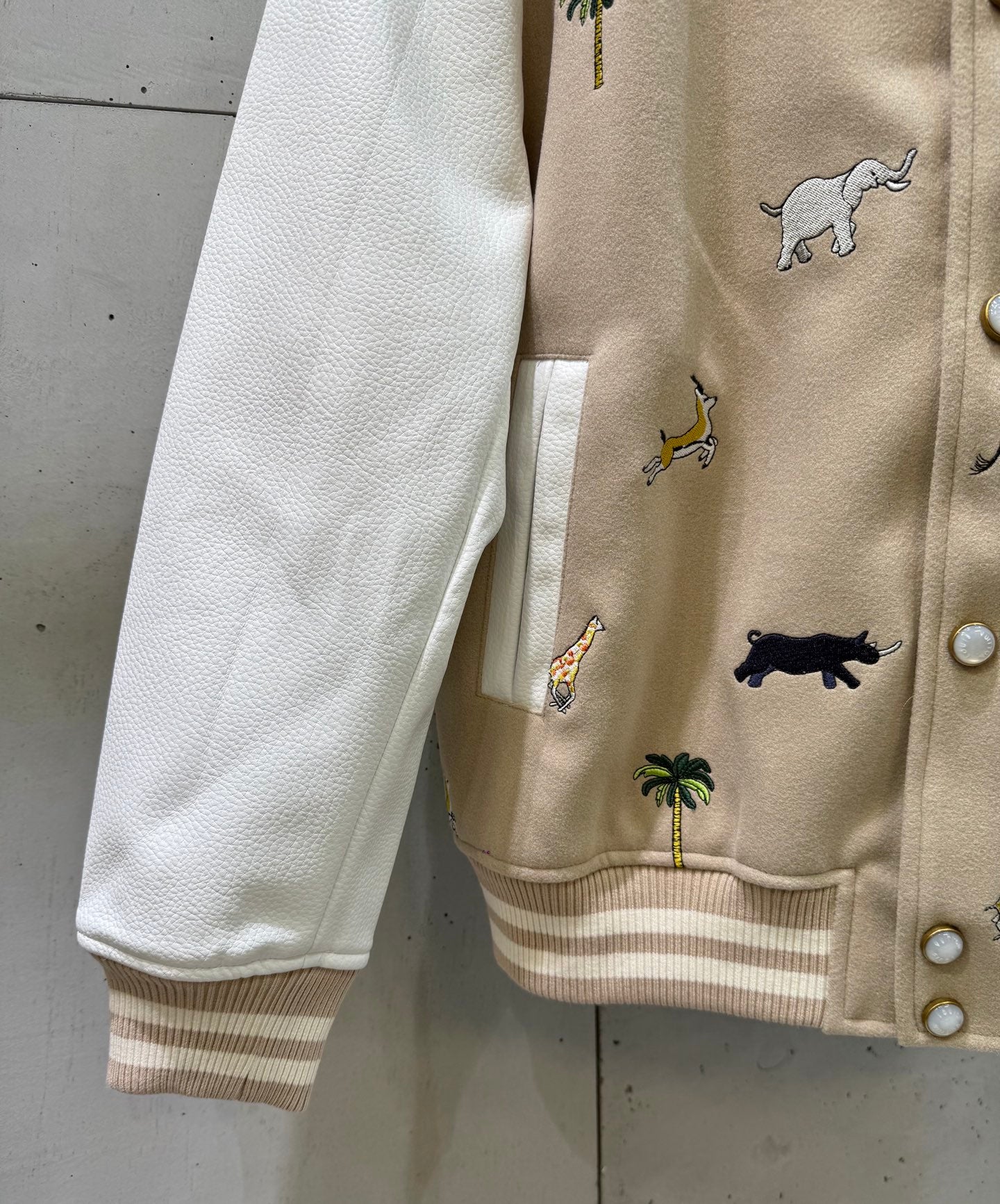 Louis Vuitton jacket sleeve and ribbed cuff with animal pattern and snap-button placket.