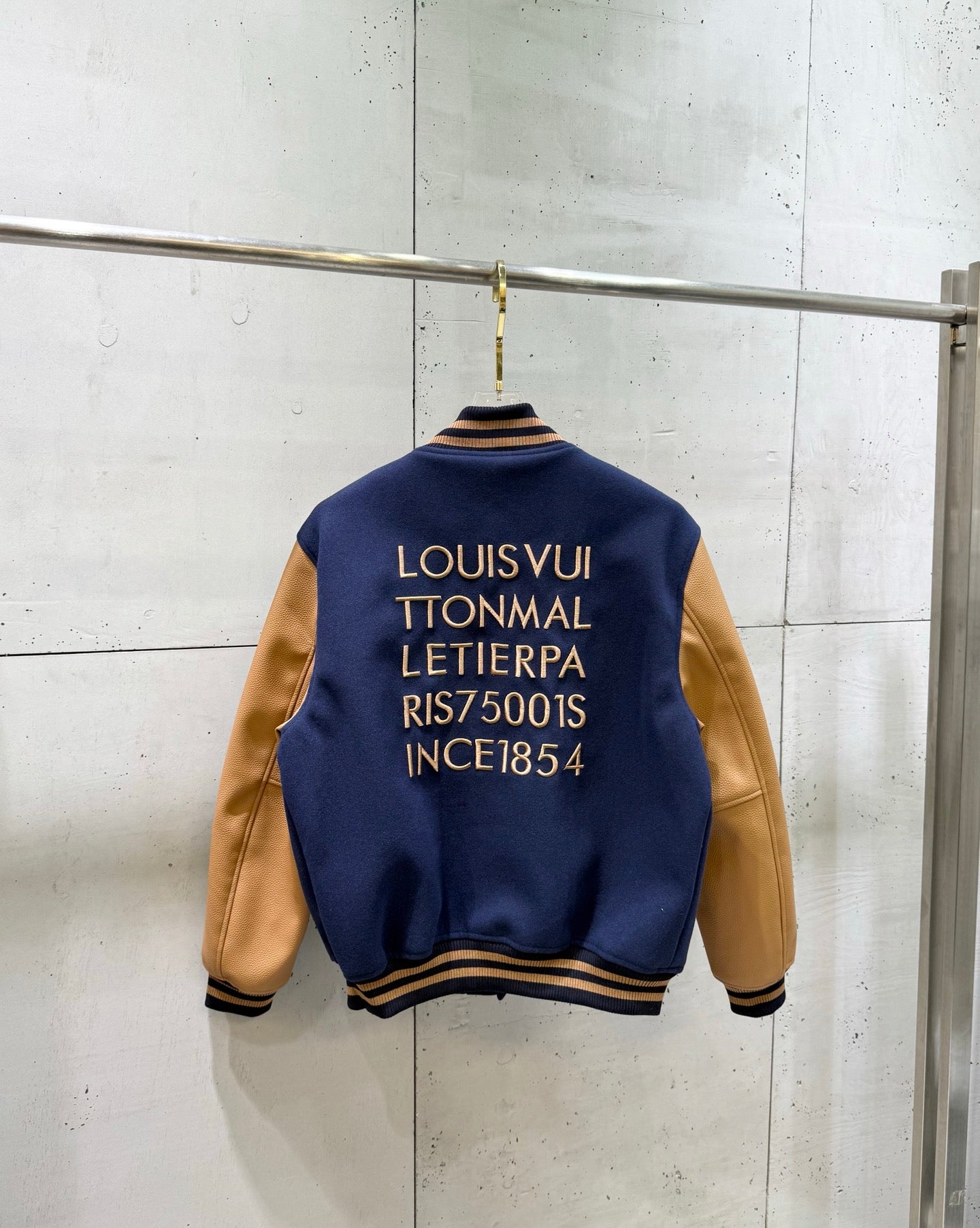 Louis Vuitton varsity jacket back with gold text and ribbed hem