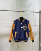 Louis Vuitton varsity jacket, navy body with tan sleeves and snap front