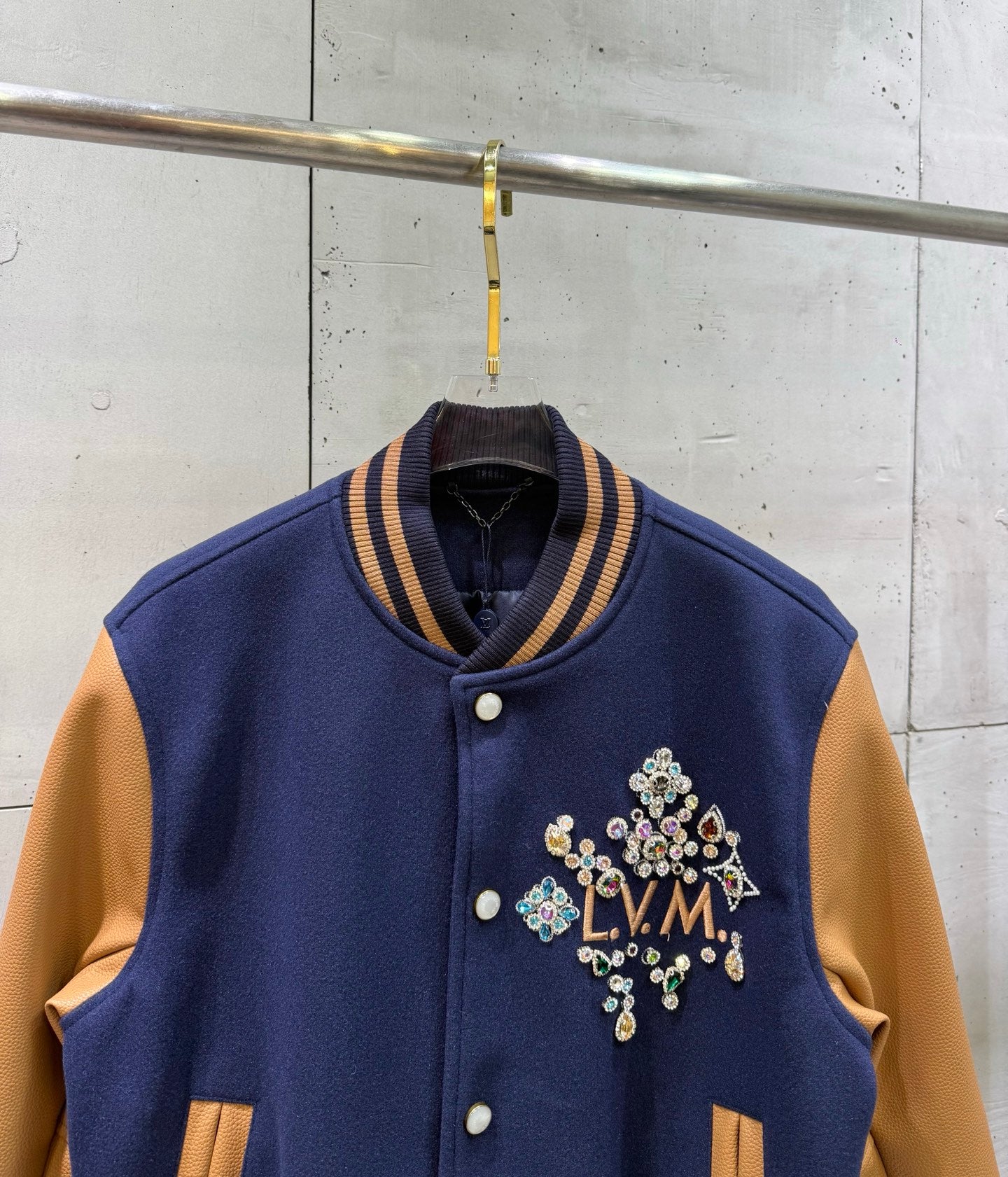 Louis Vuitton varsity jacket with ribbed striped collar and jeweled LV logo