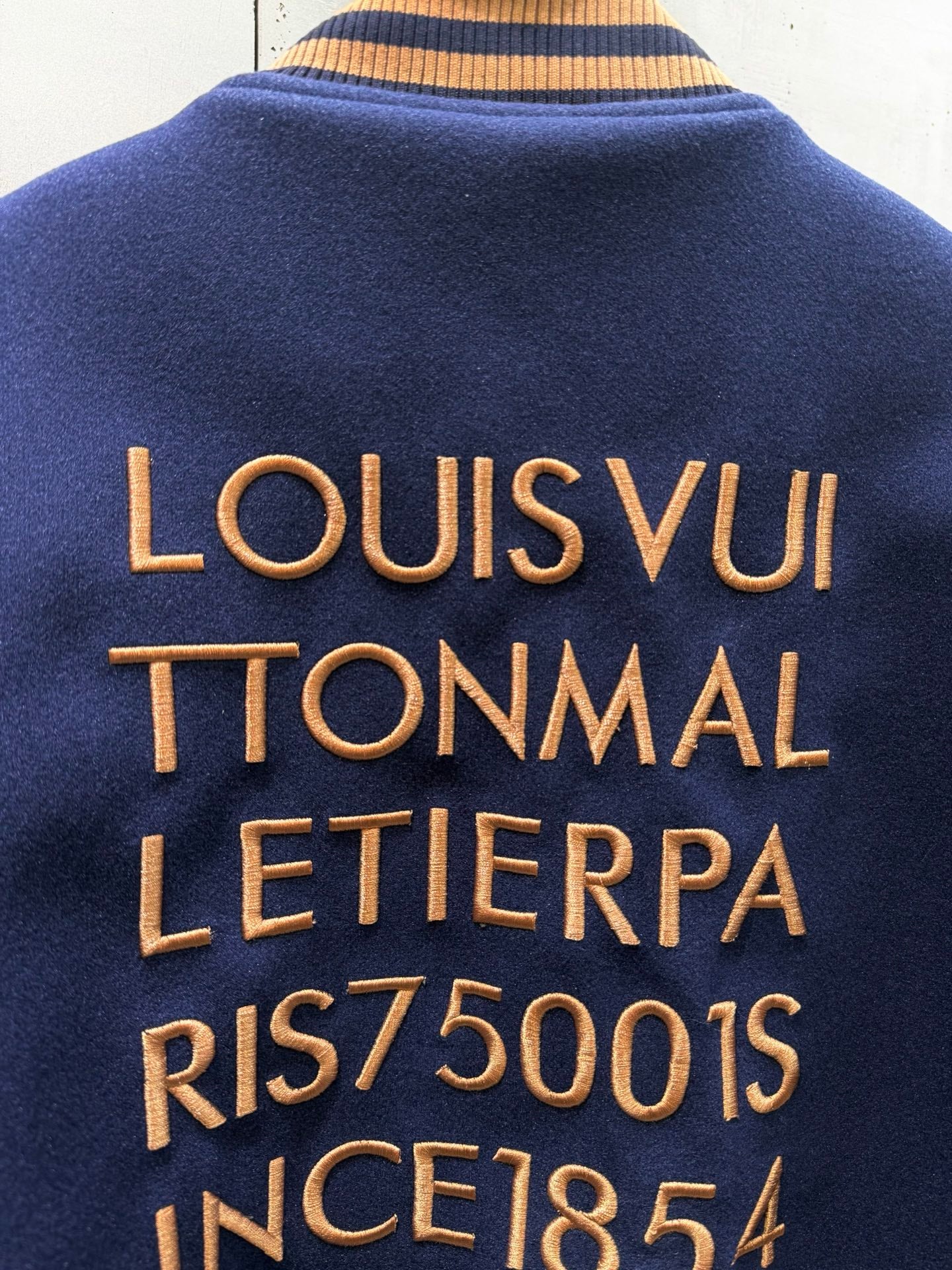 Louis Vuitton varsity jacket back text in gold lettering