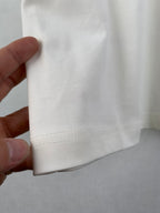 White T-shirt hem seam with stitched bottom edge detail