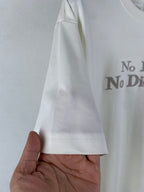 White T-shirt sleeve cuff with visible side seam stitching