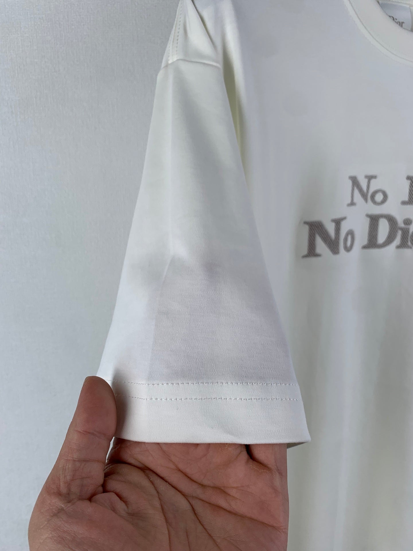 White T-shirt sleeve cuff with visible side seam stitching