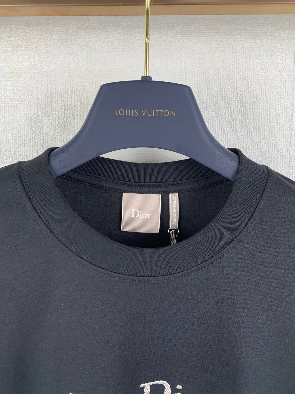 Dark gray crewneck T-shirt with inner neck label, close-up
