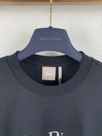 Dark gray crewneck T-shirt with inner neck label, close-up