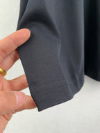 Dark gray T-shirt sleeve cuff and stitching detail, folded