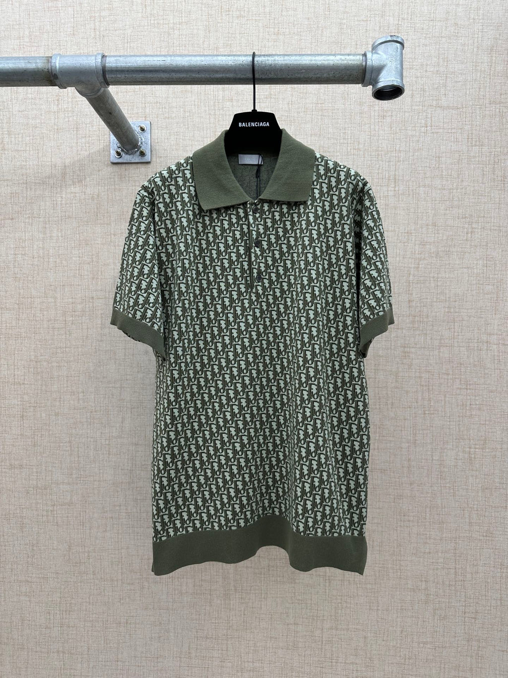 Dark green short-sleeve polo shirt with logo-style repeat print