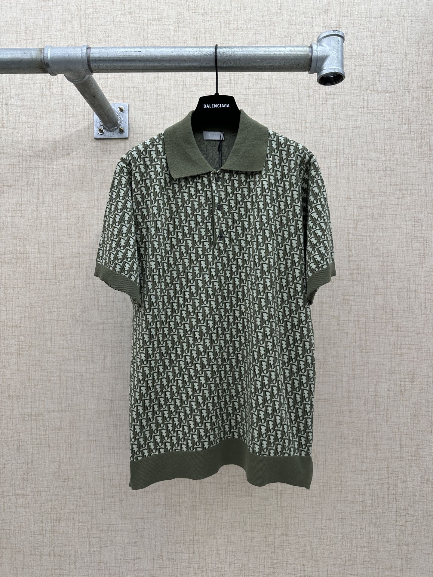 Dark green short-sleeve polo shirt with logo-style repeat print