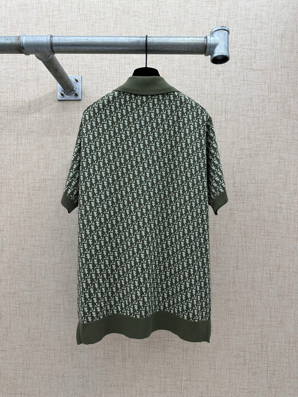 Dark green short-sleeve polo shirt back view with logo-style repeat print