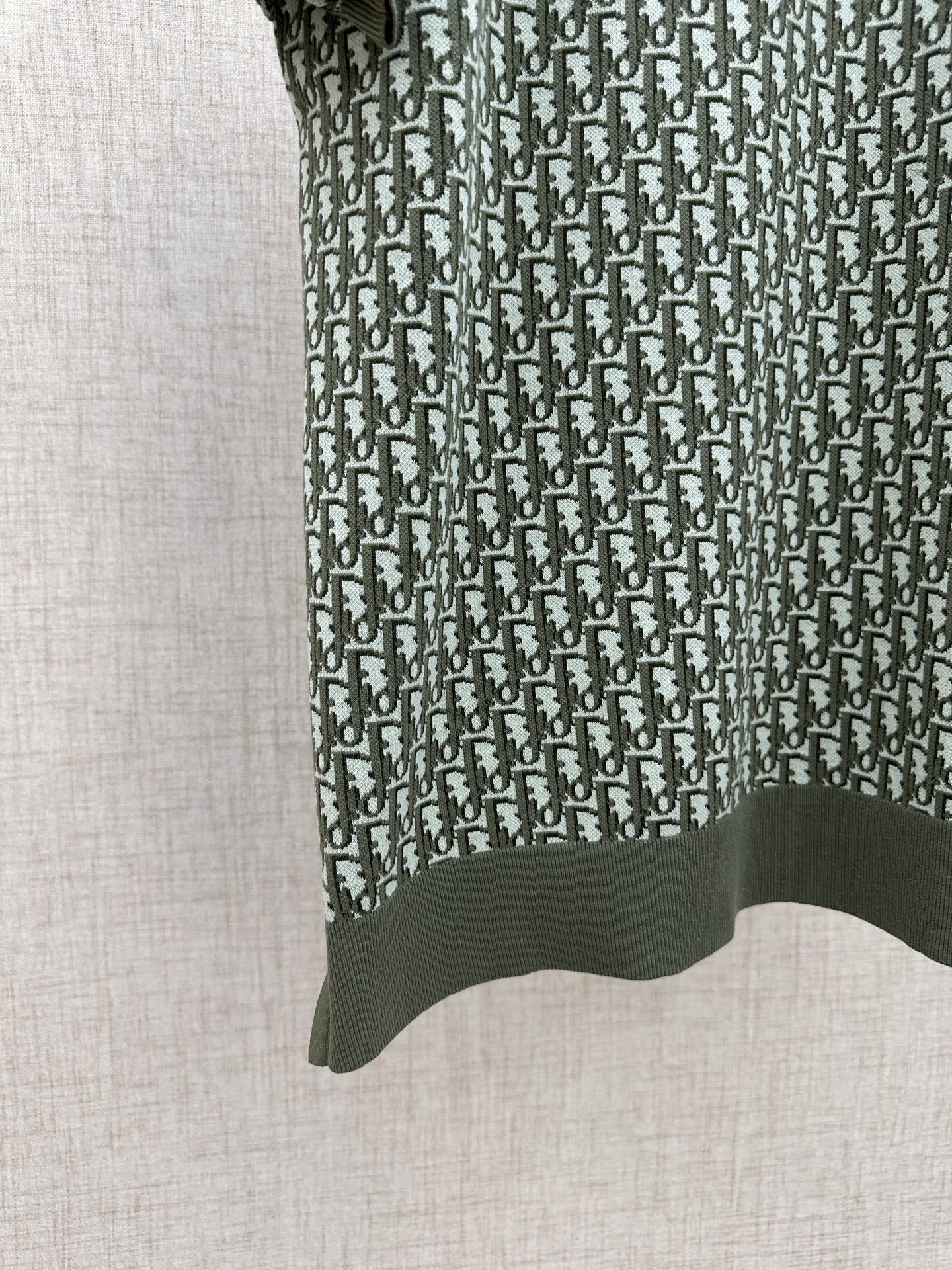 Dark green short-sleeve polo with vertical logo repeat and ribbed hem