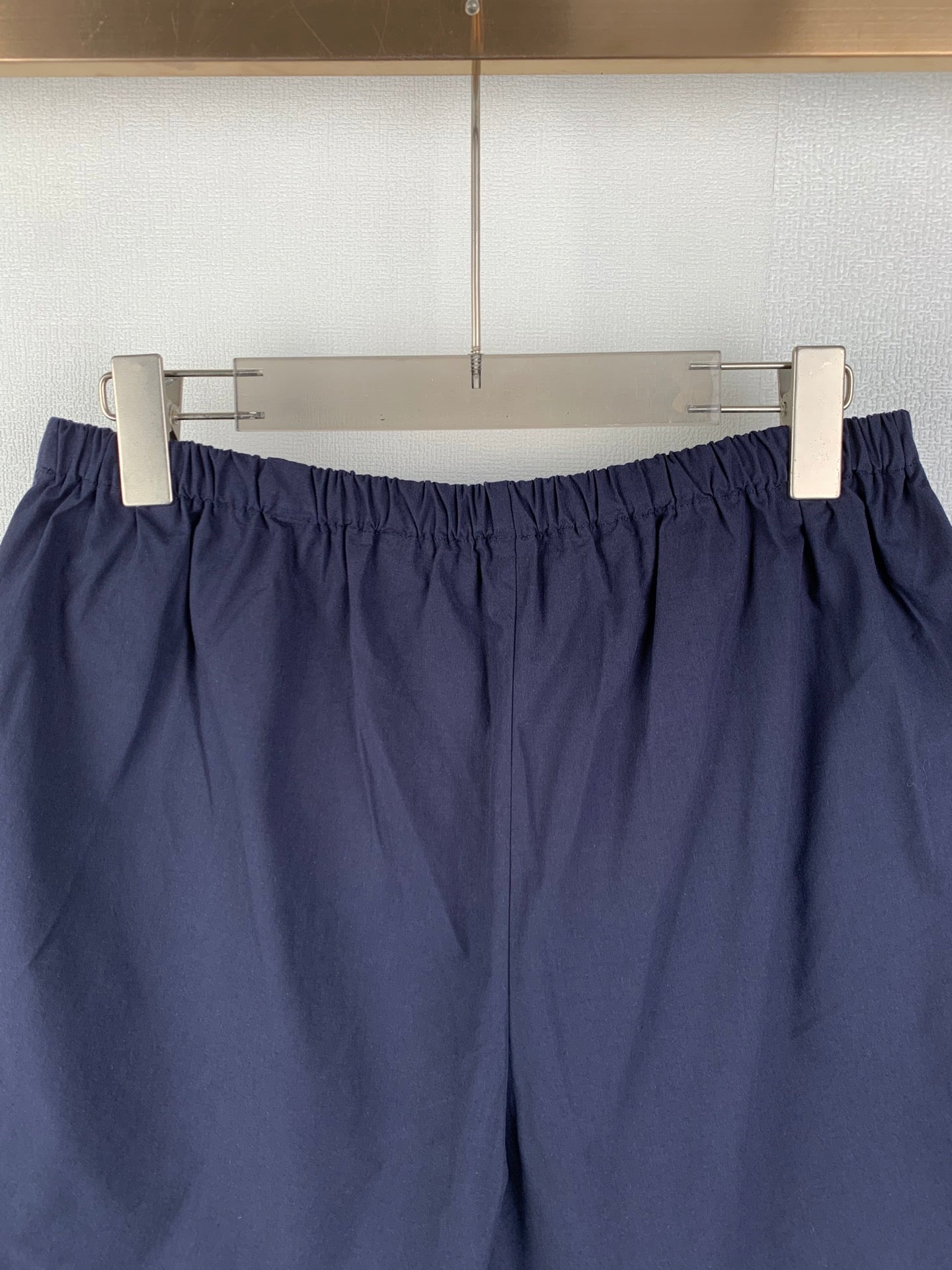 Navy Prada shorts with elastic waist and gathered front design