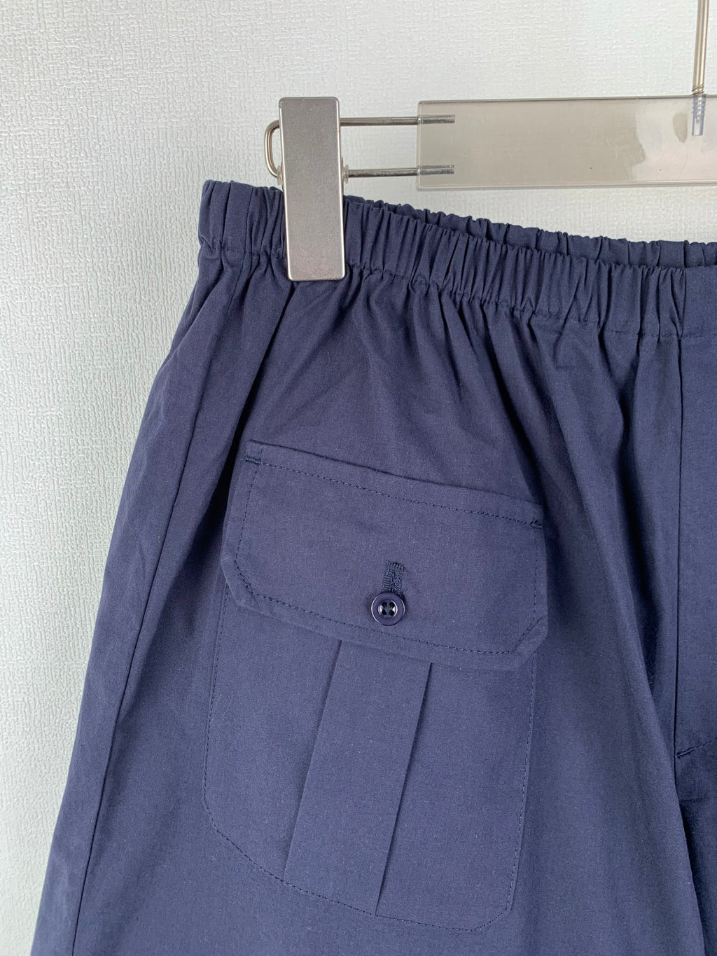 Navy Prada shorts with front pocket flap and button detail