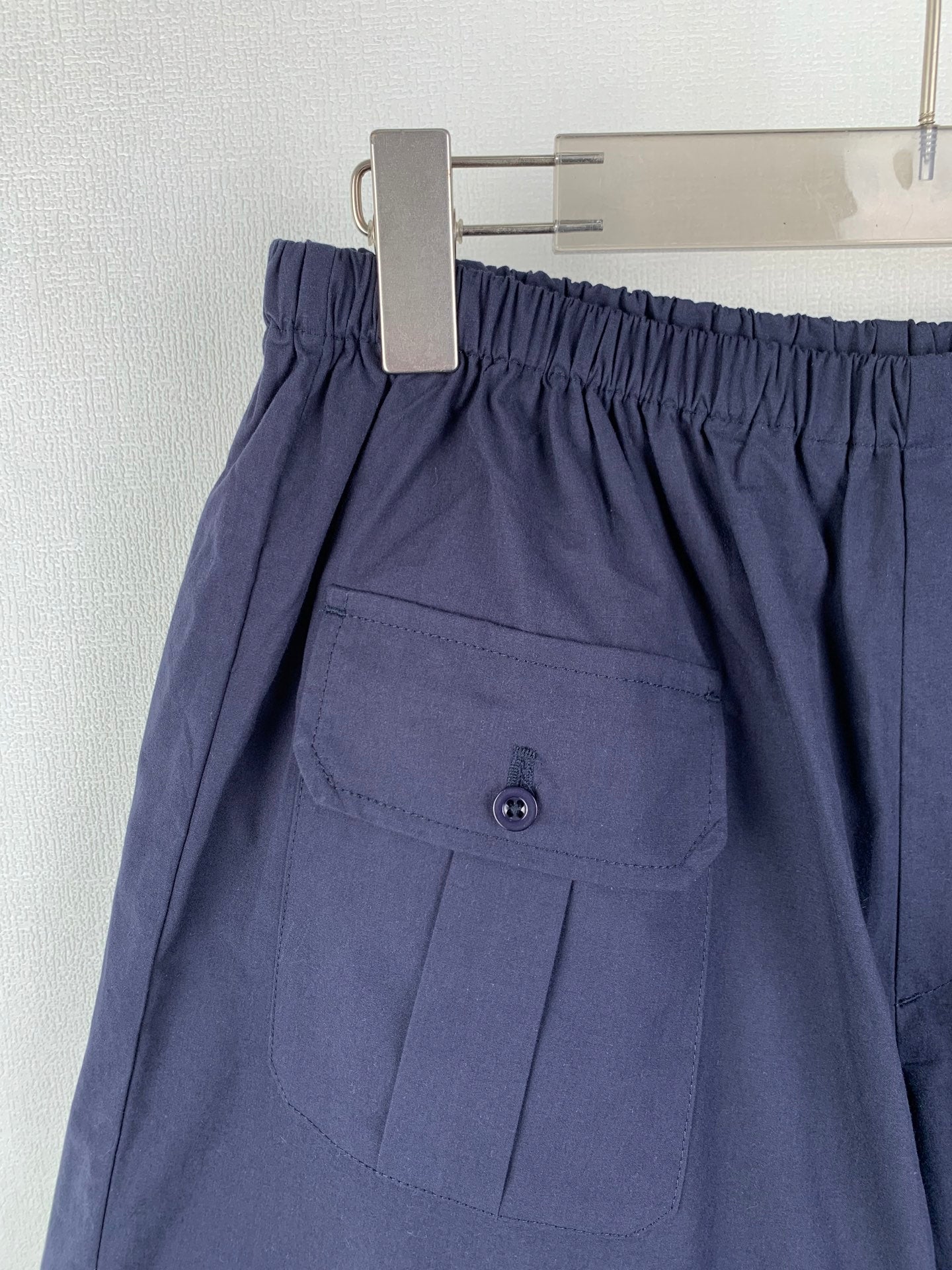 Navy Prada shorts with front pocket flap and button detail