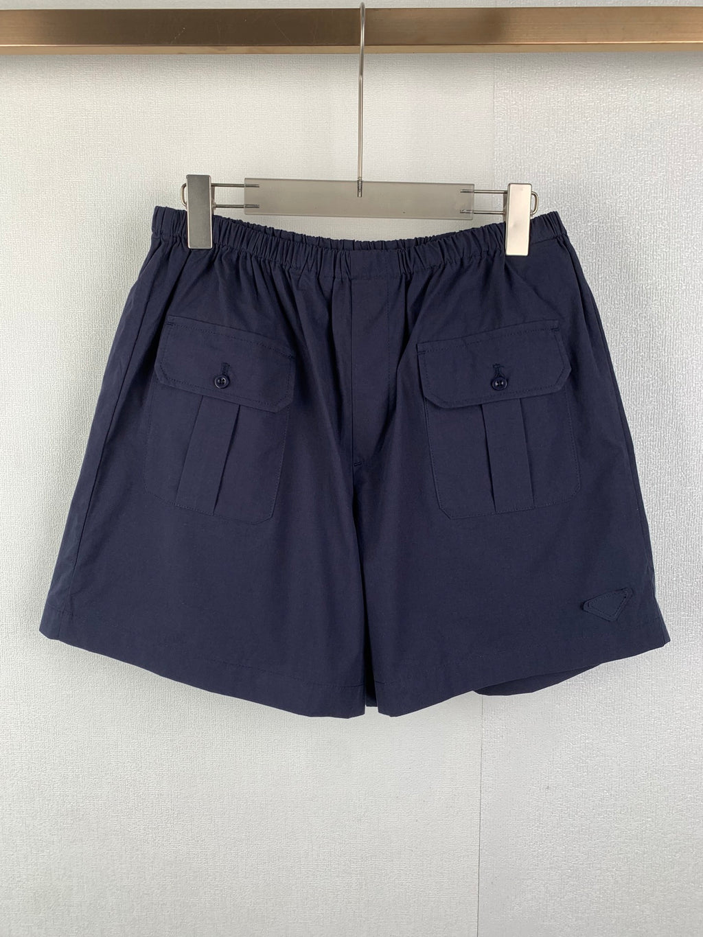 Navy Prada shorts with elastic waist and side utility pockets