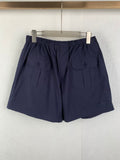 Navy Prada shorts with elastic waist and side utility pockets