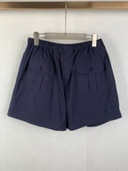Navy Prada shorts with elastic waist and side utility pockets